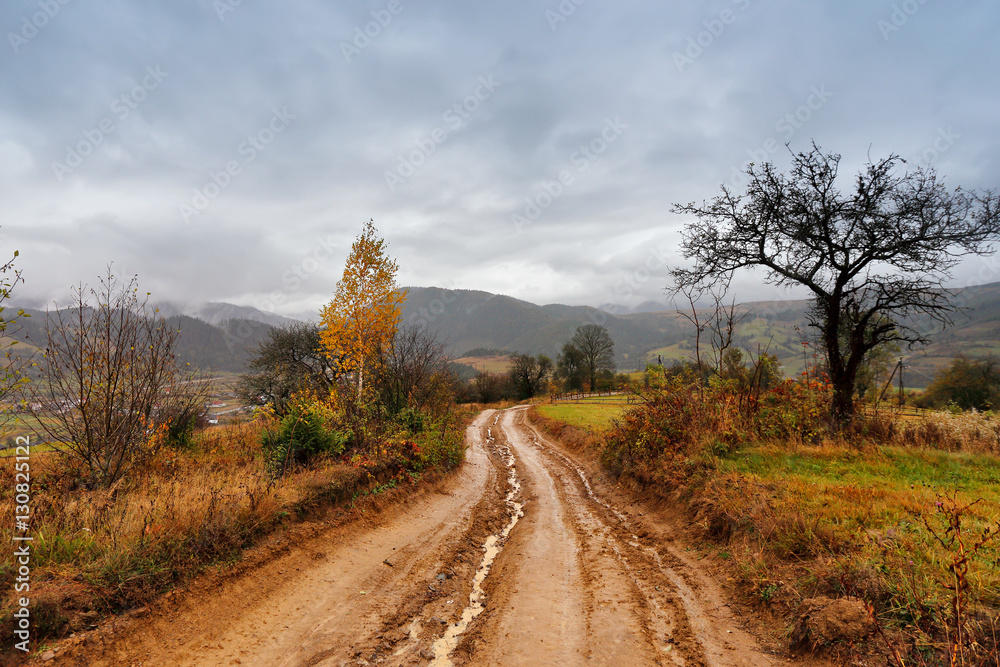 Muddy ground after rain in mountains. Extreme path rural dirt ro