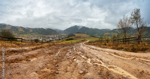 Obraz na płótnie Muddy ground after rain in mountains. Extreme path rural dirt ro w salonie