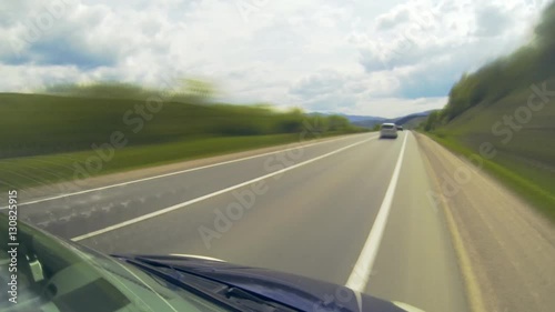 Driving on the highway in the mountains. Point of view camera filming. Time lapse.