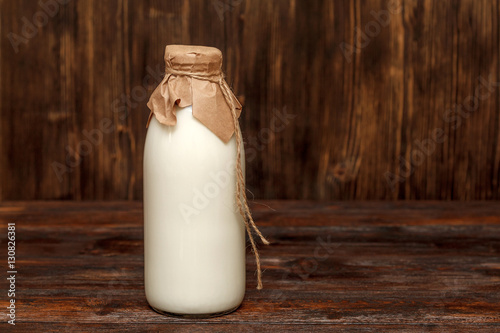 Bottle of milk on rustic wooden table