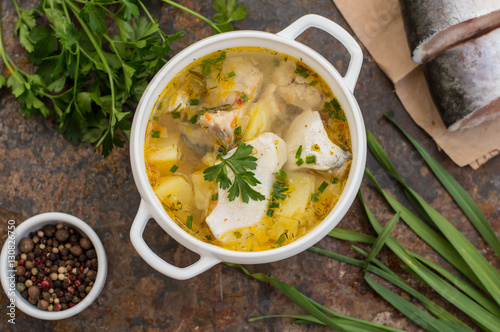 Fresh fish soup with ingredients and spices for cooking. Wooden background. Top view. Close-up