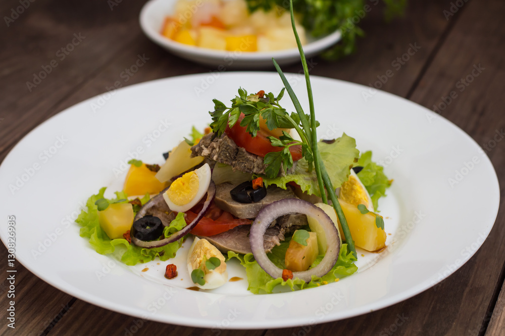 Salad with tongue on the wooden background Salad with tongue on the wooden background