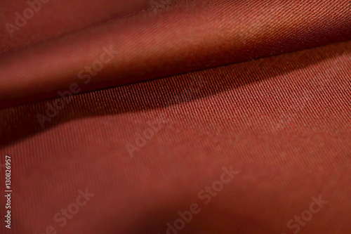 close up roll auburn fabric of suit