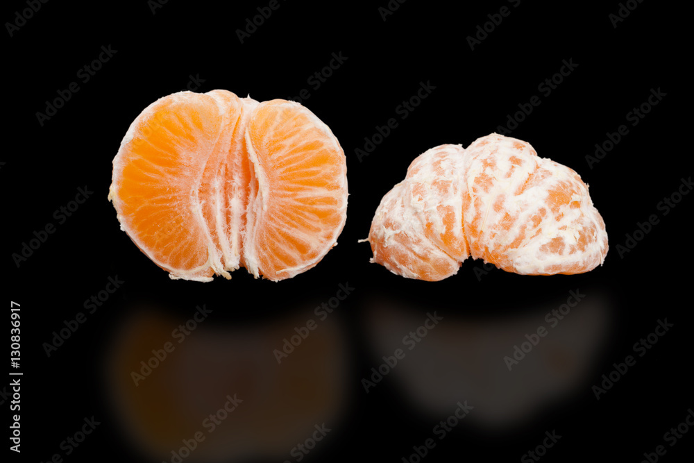 Juicy mandarin, two Half peeled mandarin on pure black. Juicy mandarin, two Half peeled mandarin on pure black.