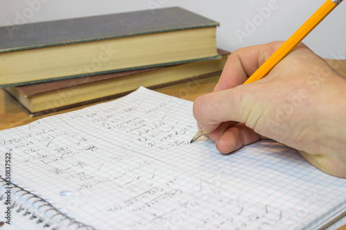 Hand Writing in Messy Math Notebook
