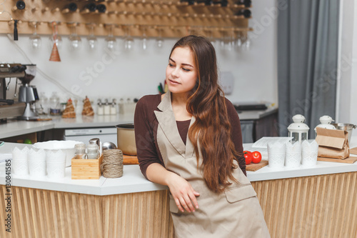 Fotografi Portrait of beautiful young barmaid wearing apron