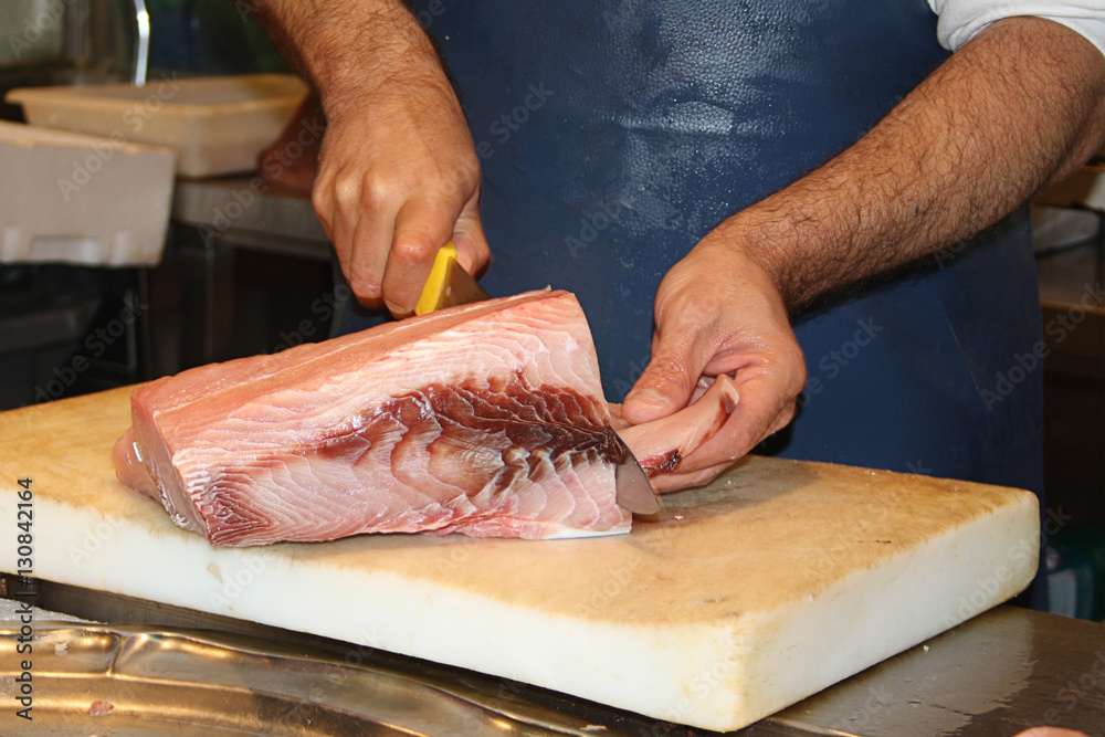cutting fish fillet in a fish shop