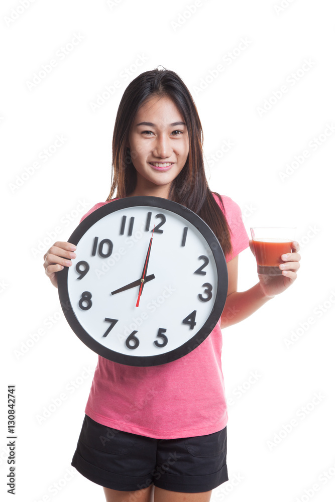 Young Asian business woman with tomato juice and clock. Young Asian business woman with tomato juice and clock.