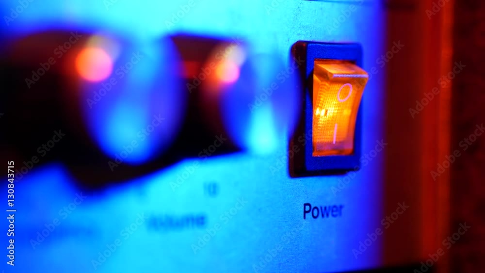A power switch being turned on and off by man