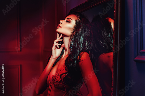 Seductive brunette woman in the red place © konradbak