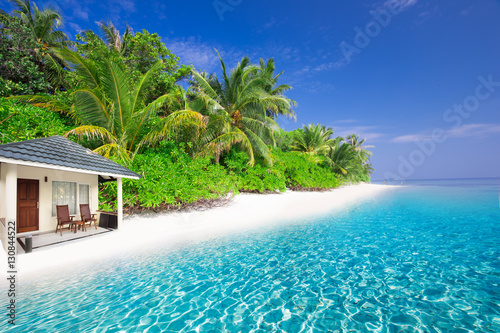 Fototapeta Naklejka Na Ścianę i Meble -  Luxurious over-water bungalows in beautiful lagoon on tropical island