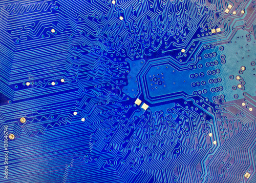 Technological background with blue computer motherboard closeup