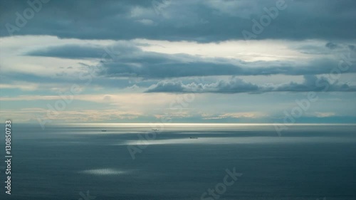 Wallpaper Mural Strait of Gibraltar Mediterranean Ocean Seascape with Cargo Tanker Ships lit by Pool of Sunlight in Calm Sea Water Surface under a Cloudy Sky Torontodigital.ca