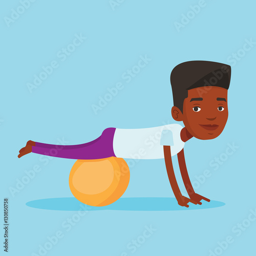 Young man exercising with fitball.