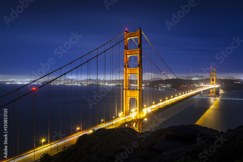 Golden Gate Bridge in San Francisco, California at night with traffic light trails.