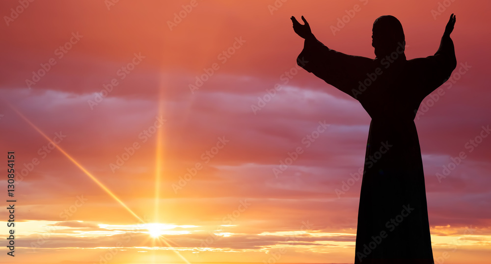 Jesus Christ statue against beautiful sky background