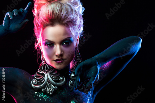 Fotografie Young attractive blonde girl in bright art-makeup, in purple tones