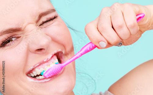 Woman brushing cleaning teeth