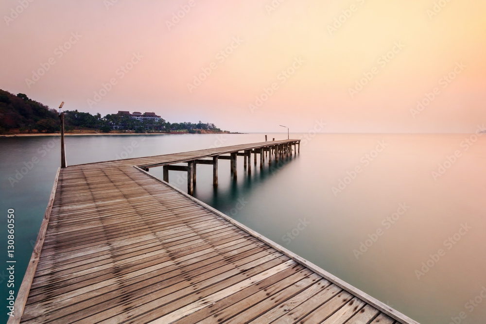 Fototapeta premium Wood bridge on the sea with sunset 
