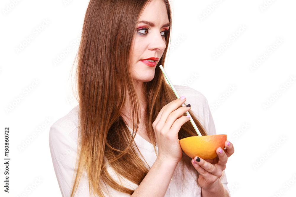 Woman holds grapefruit drinking juice from fruit