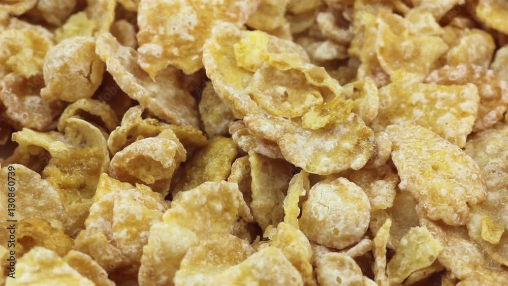 Heap of breakfast crispy corn flakes, rotating, closeup view Heap of breakfast crispy corn flakes, rotating, closeup view