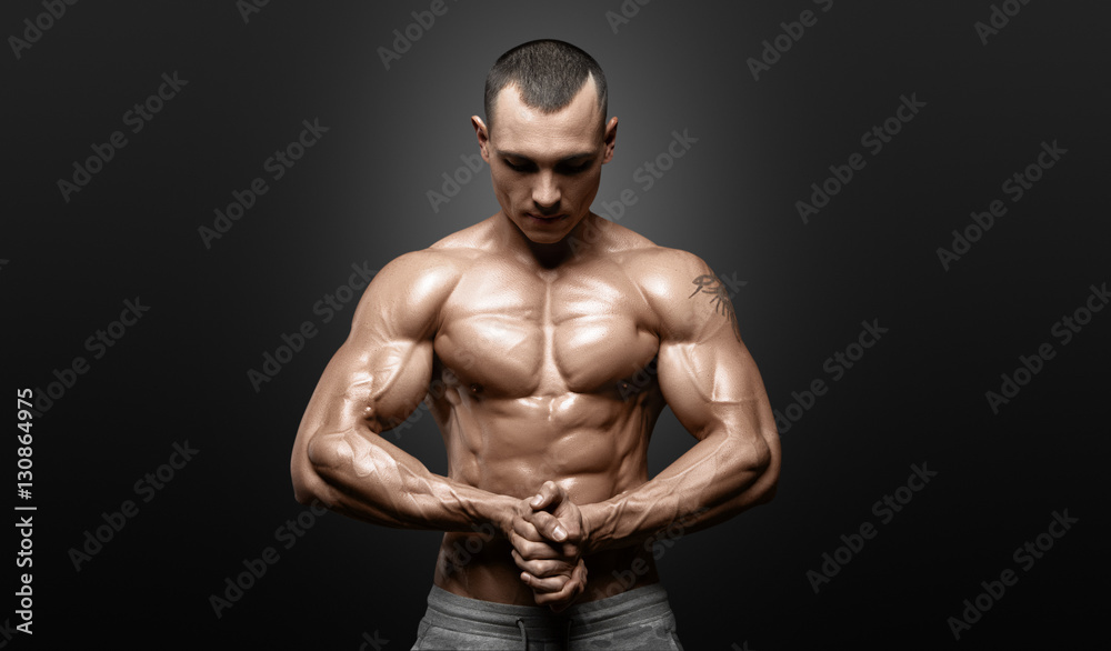 Fototapeta premium Strong Athletic Man Fitness Model Torso showing six pack abs.