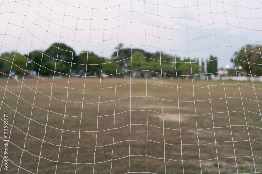 Net of goal in football (soccer) field at evening time soccer goal