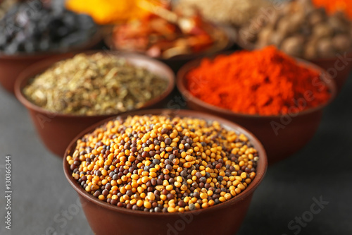 Different spices in bowls on table