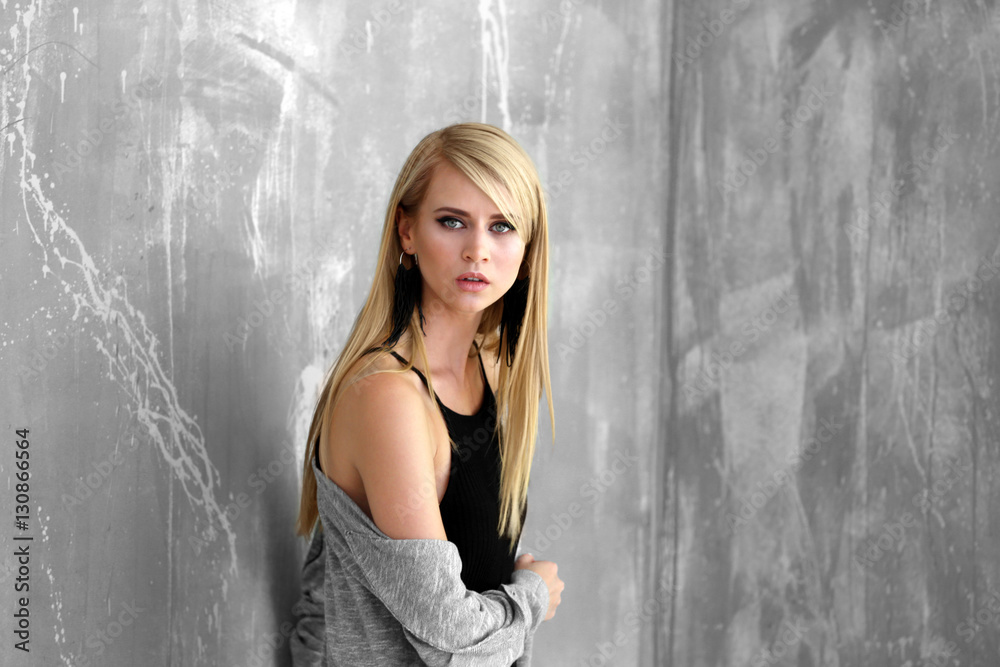 Fototapeta premium Portrait of pretty young woman against grunge background