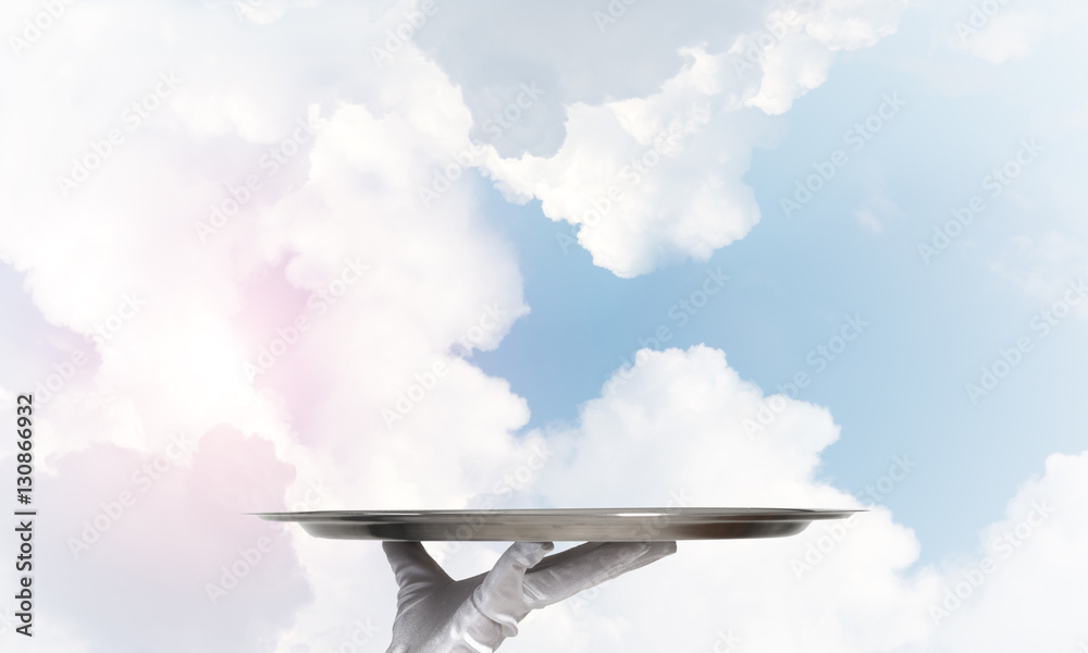 Waiter holding empty silver platter ready for product or item placement