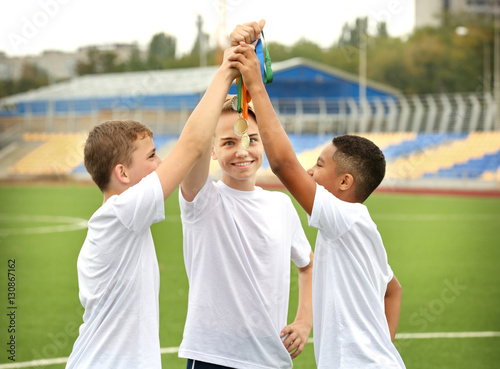 Happy winners holding medal...