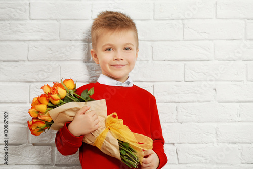 Cute boy with bouquet of be...