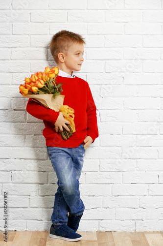 Cute boy with bouquet of be...
