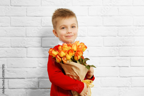 Cute boy with bouquet of be...