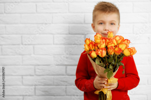 Cute boy with bouquet of be...