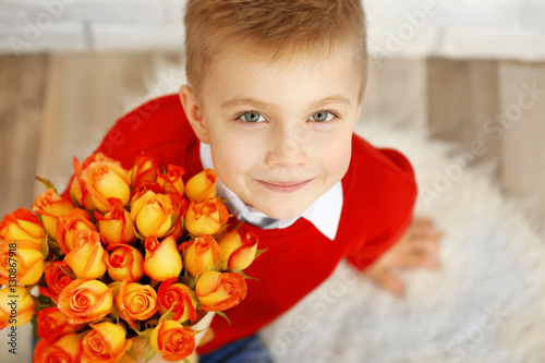 Cute boy with bouquet of be...