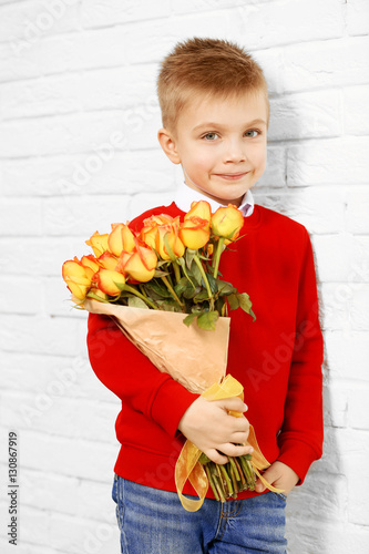 Cute boy with bouquet of be...