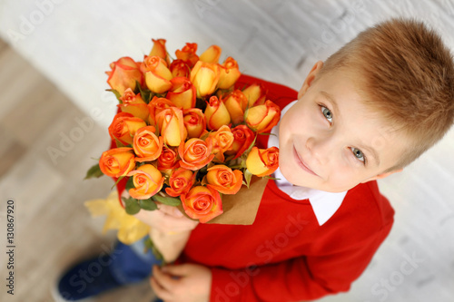 Cute boy with bouquet of be...