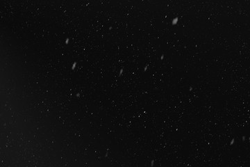 Rain or snow fall concept. Falling raindrops on black background