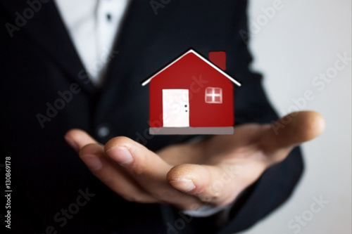 man holding house