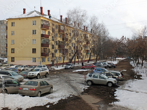 Уфа. Виды города. Жилой пятиэтажный дом и припаркованные во дворе автомобили пасмурным зимним днем