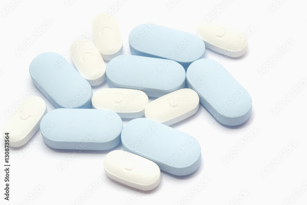 Macro shot of white and blue drugs on white background Macro shot of white and blue drugs on white background