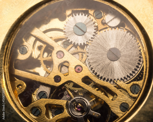 Close up macro shot of golden clock mechanism