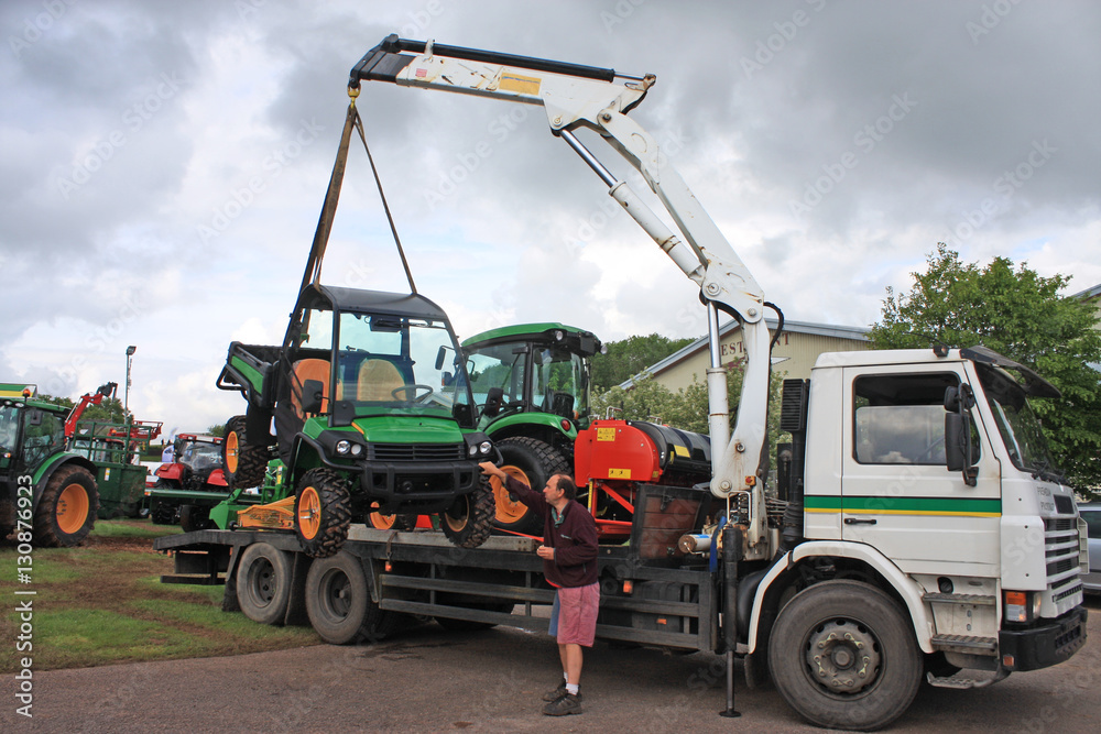 man loading agricultural machinery