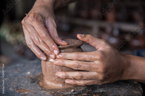 pottery making. hand transforming clay close up