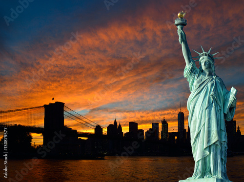 Statue of Liberty and Manhattan at sunset.