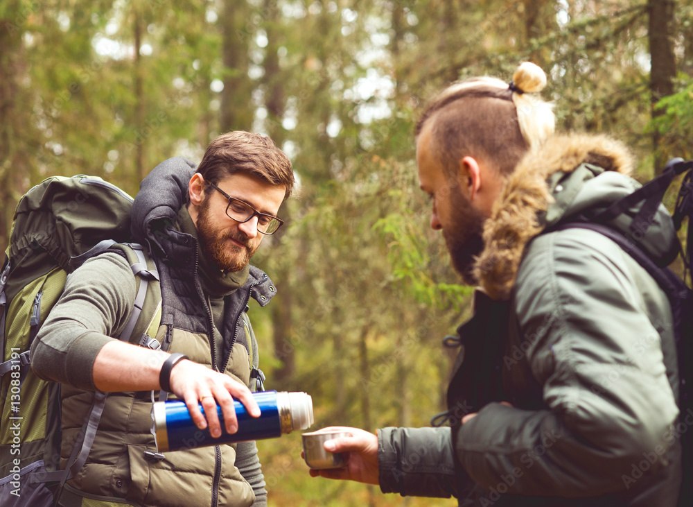 Fototapeta premium Man with a beard and his friend hiking in a forest