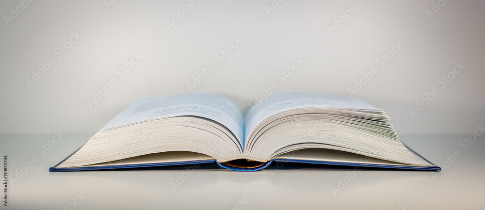 Opened book on the table - ancient knowledge Opened book on the table - ancient knowledge