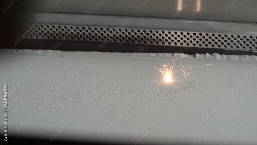 3D Printer during work. Selective laser sintering is an additive manufacturing technique that uses a laser as the power source to sinter powdered material.