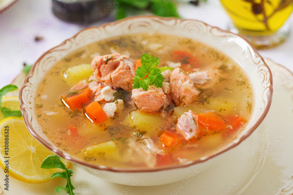 Salmon soup with vegetables in bowl